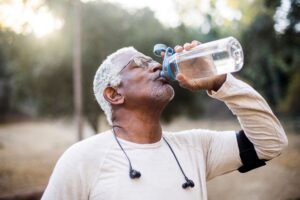 older-aged man drinking water
