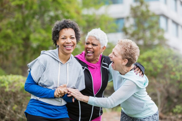 group of older aged adult women outdoors laughing
