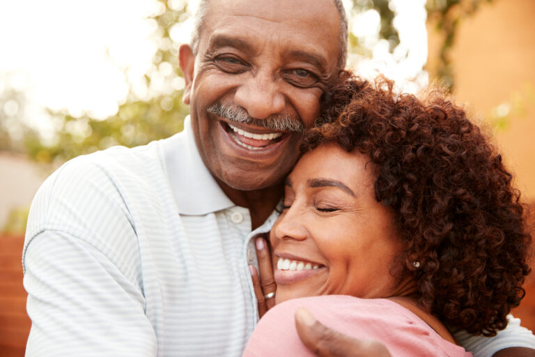 older couple smiling and embracing