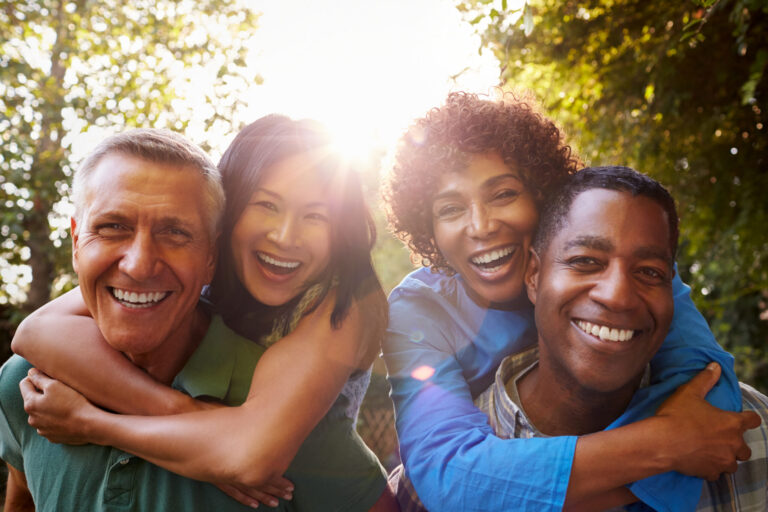 two older aged adult couples posing for photo