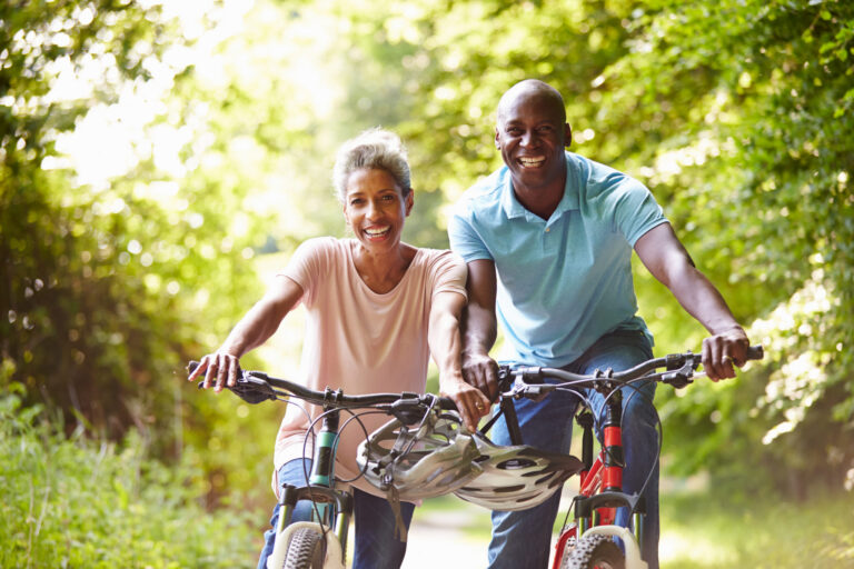 older aged couple enjoying a bike ride together