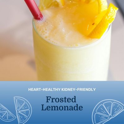frosted lemonade drink with lemon on top in a cup